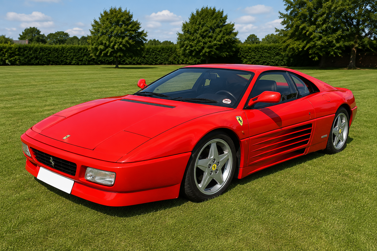 Red Ferrari 348 berlinetta parked on a manicured lawn, showing the Pininfarina-designed side strakes, pop-up headlamps and five-spoke alloy wheels.