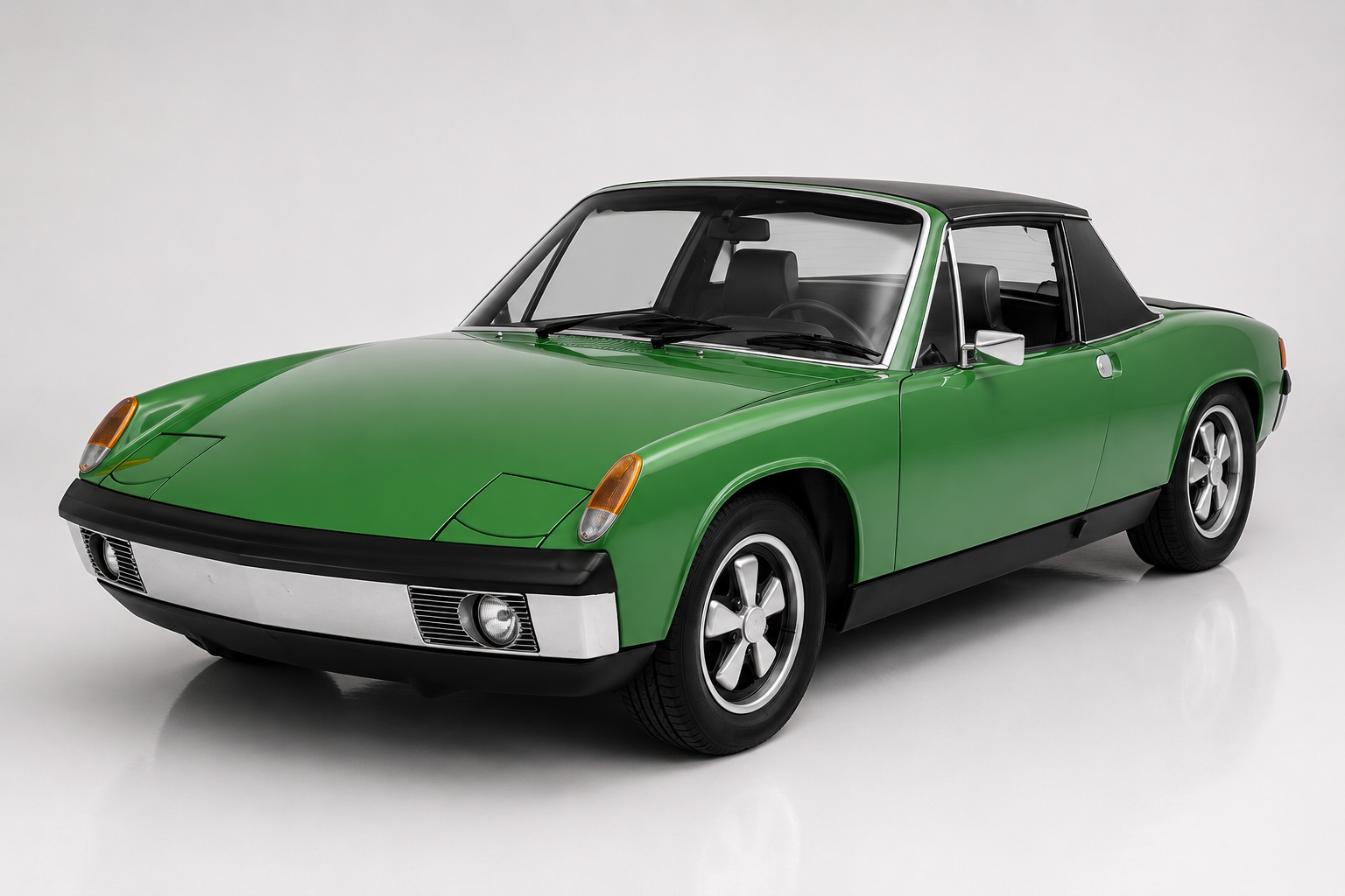 Green Porsche 914 in a studio setting, front three-quarter view showing the low targa two-seater bodywork with black nose section, pop-up headlamps, black targa roof panel and alloy wheels.