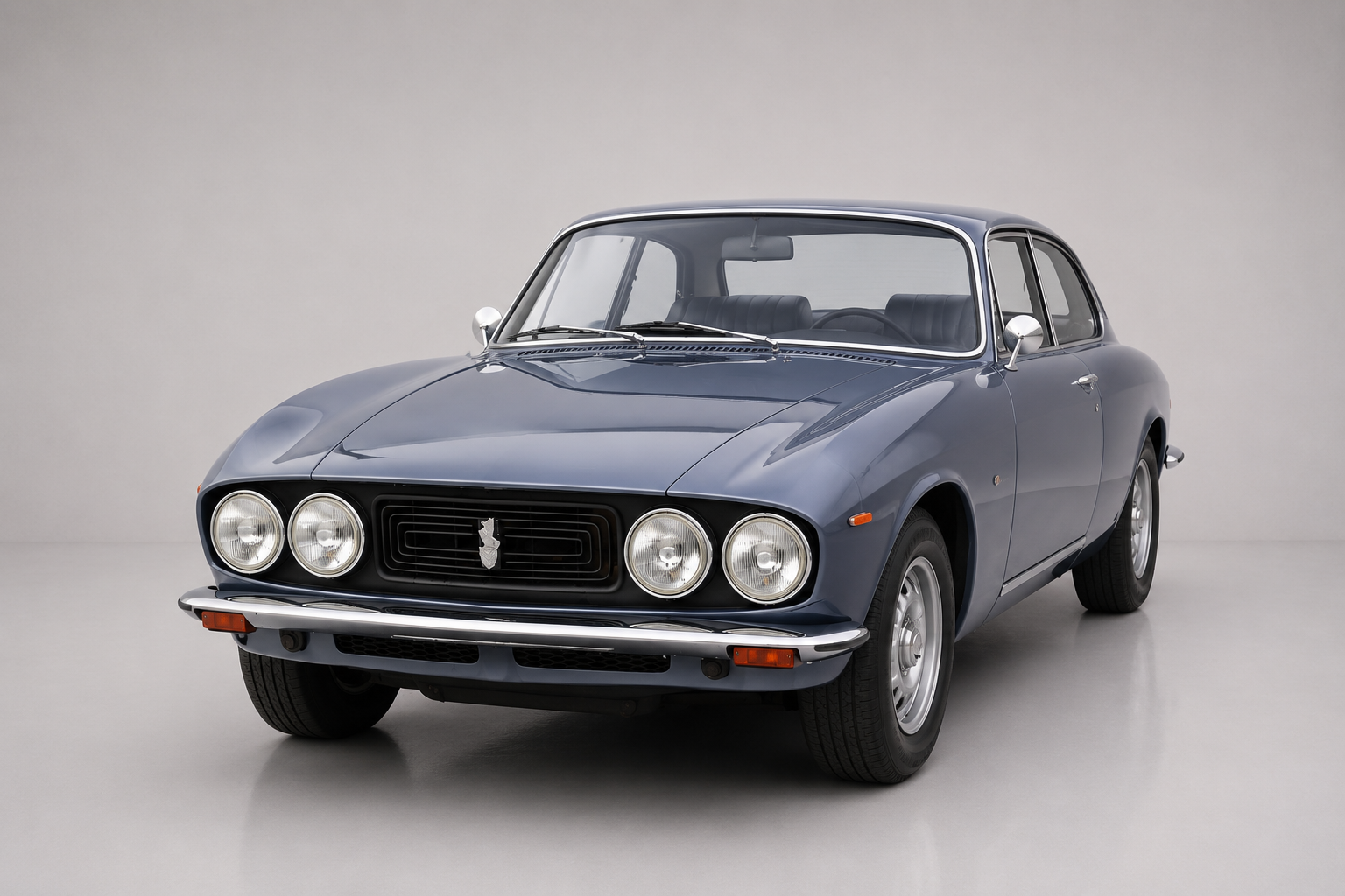 Slate-blue Bristol 411 two-door saloon, front three-quarter studio view, showing four round headlamps, a black grille, chrome bumper and Chrysler-V8-era coachwork.