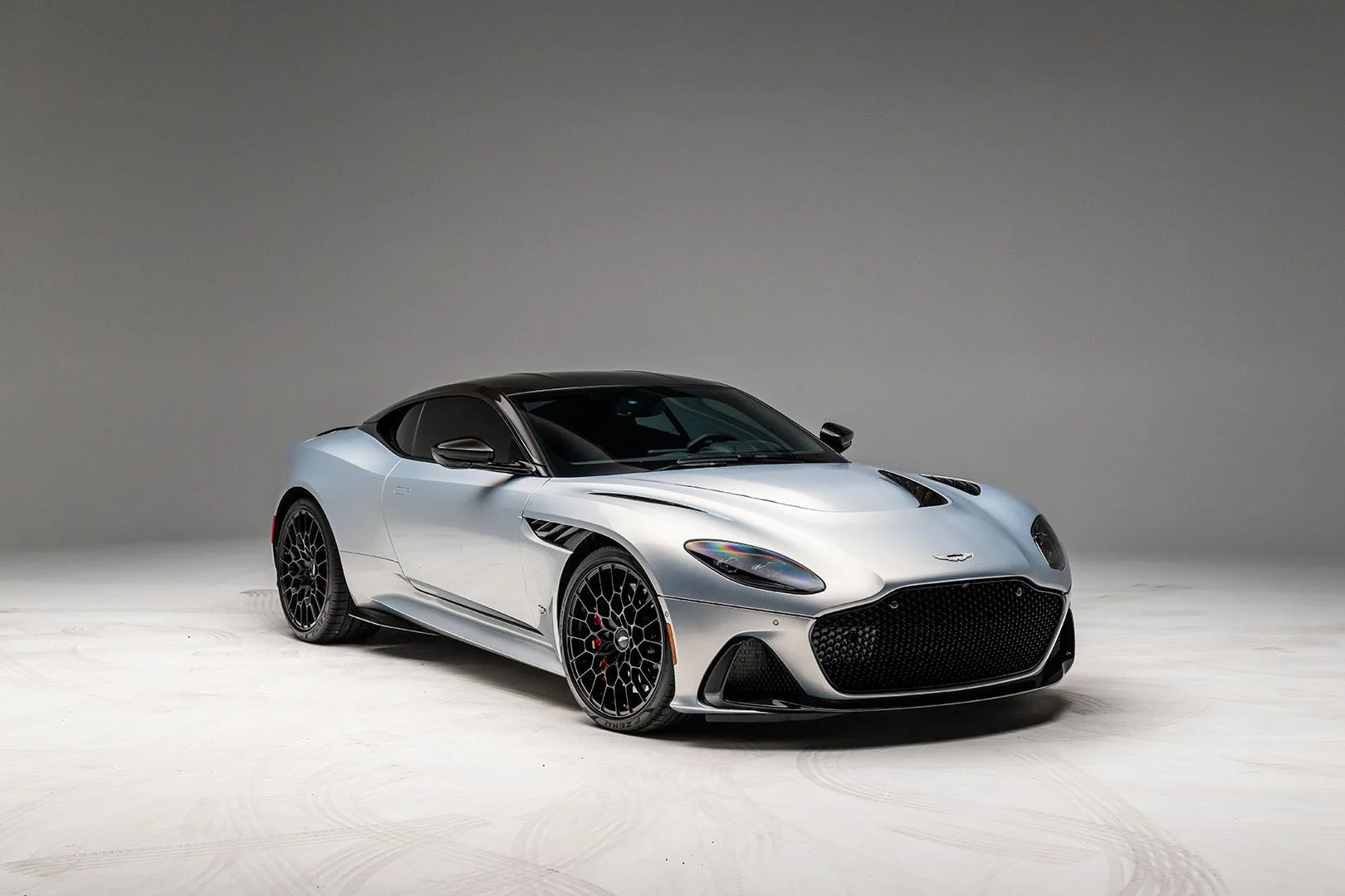 Aston Martin DBS Superleggera in silver with a black roof, front three-quarter view