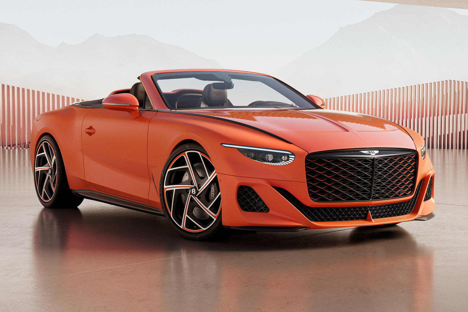 Orange Bentley Mulliner Batur Convertible in front three-quarter view, photographed in a showroom-style setting with fluted screen wall and stone floor