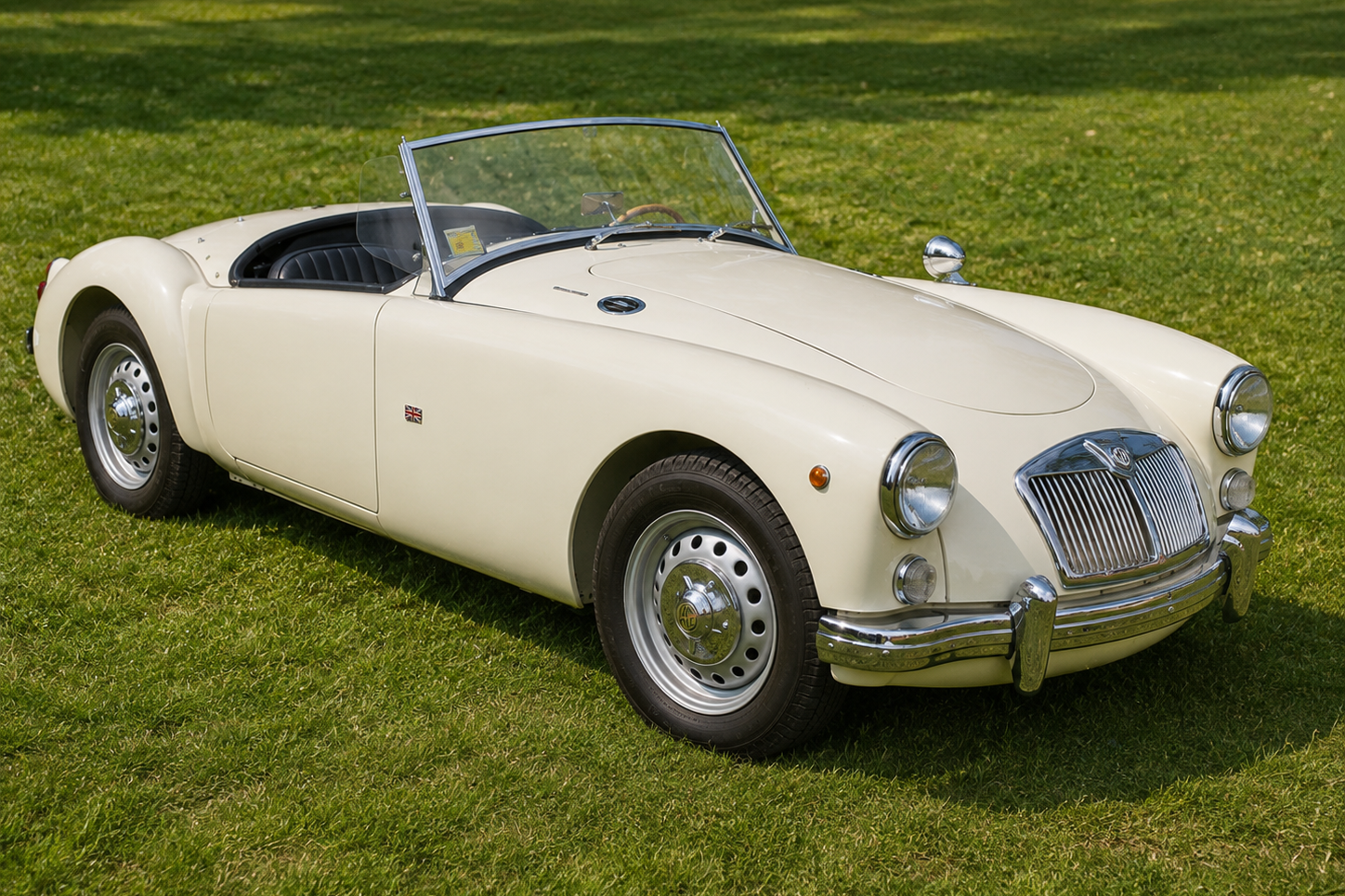 MG MGA Roadster in Old English White, front three-quarter view on grass at a concours / showroom setting — the definitive post-war MG sports car, produced 1955–1962.