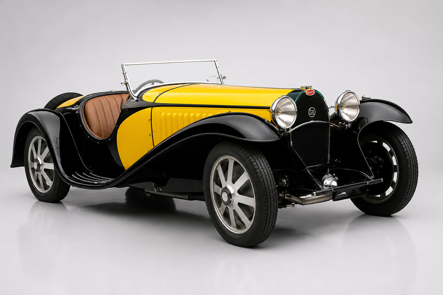 Black and yellow Bugatti Type 55 roadster, front three-quarter studio view, showing cycle-style front wings, the horseshoe grille, cut-down doors and right-hand-drive cockpit.