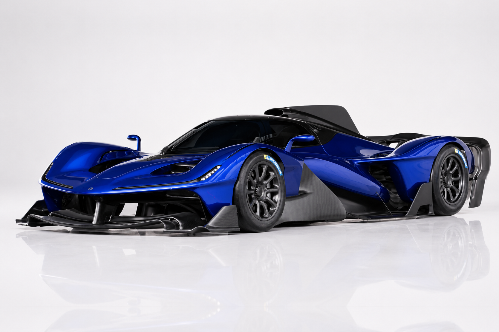 Deep blue Red Bull RB17 track-only hypercar in a studio setting, front three-quarter view showing the exposed prototype-style aerodynamic bodywork, low nose section, complex front splitter and open-wheel-inspired suspension.