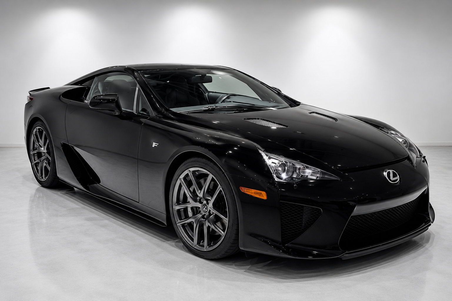 Black Lexus LFA supercar in a studio setting.