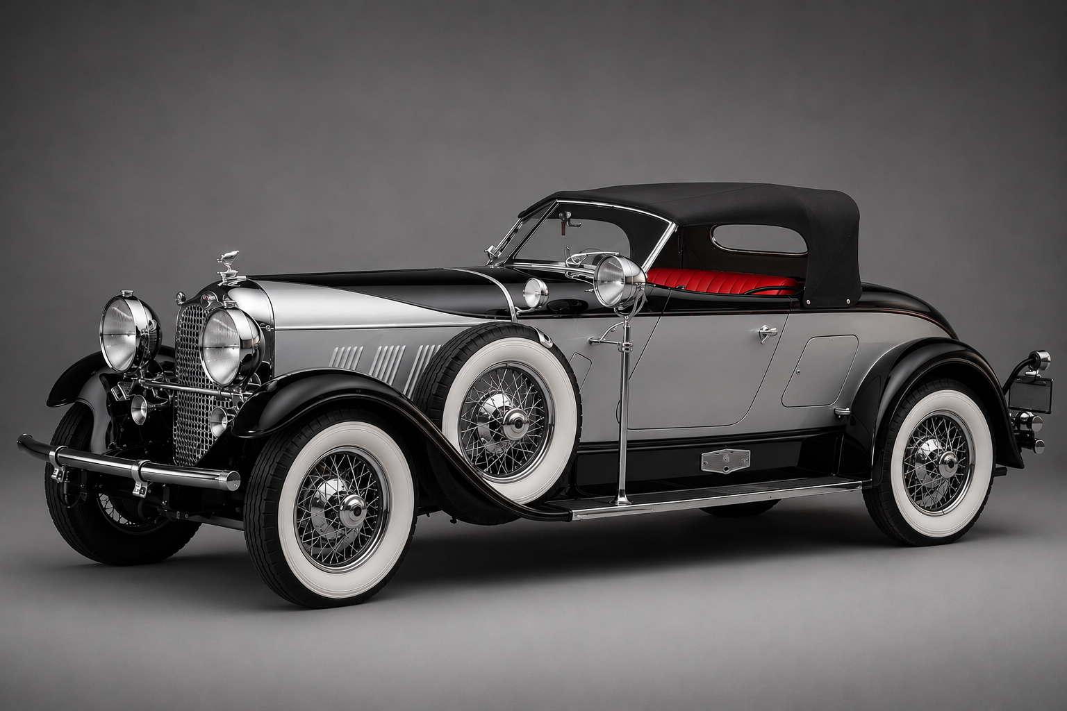 Auburn 8-120 Boattail Speedster in polished silver and black, front three-quarter studio view against a dark grey backdrop, showing the Alan Leamy and Count Alexis de Sakhnoffsky two-seat open body with pointed boat-tail rear deck, raked V'd windscreen, extensive hood louvres, deep chrome grille with bird radiator mascot, side-mounted spare wheel, chrome-plated side lamps, whitewall tyres on wire wheels, and the deep buttoned red leather cockpit set well back on the long chassis.