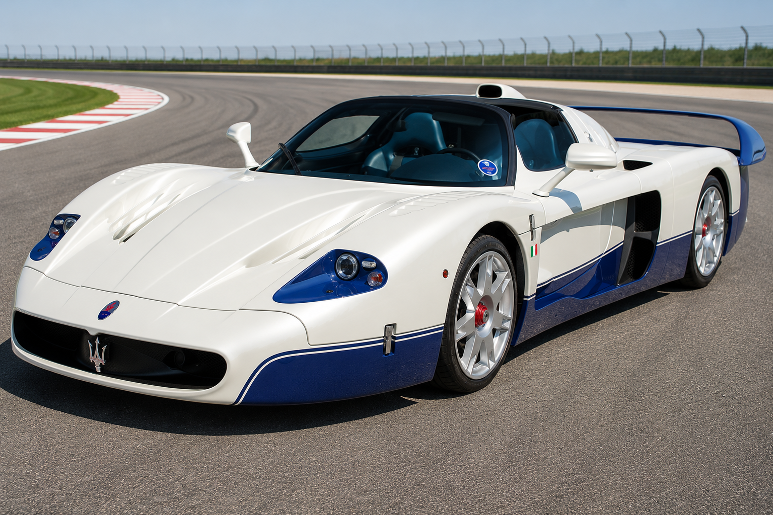 White and blue Maserati MC12 homologation hypercar on a racetrack, front three-quarter view