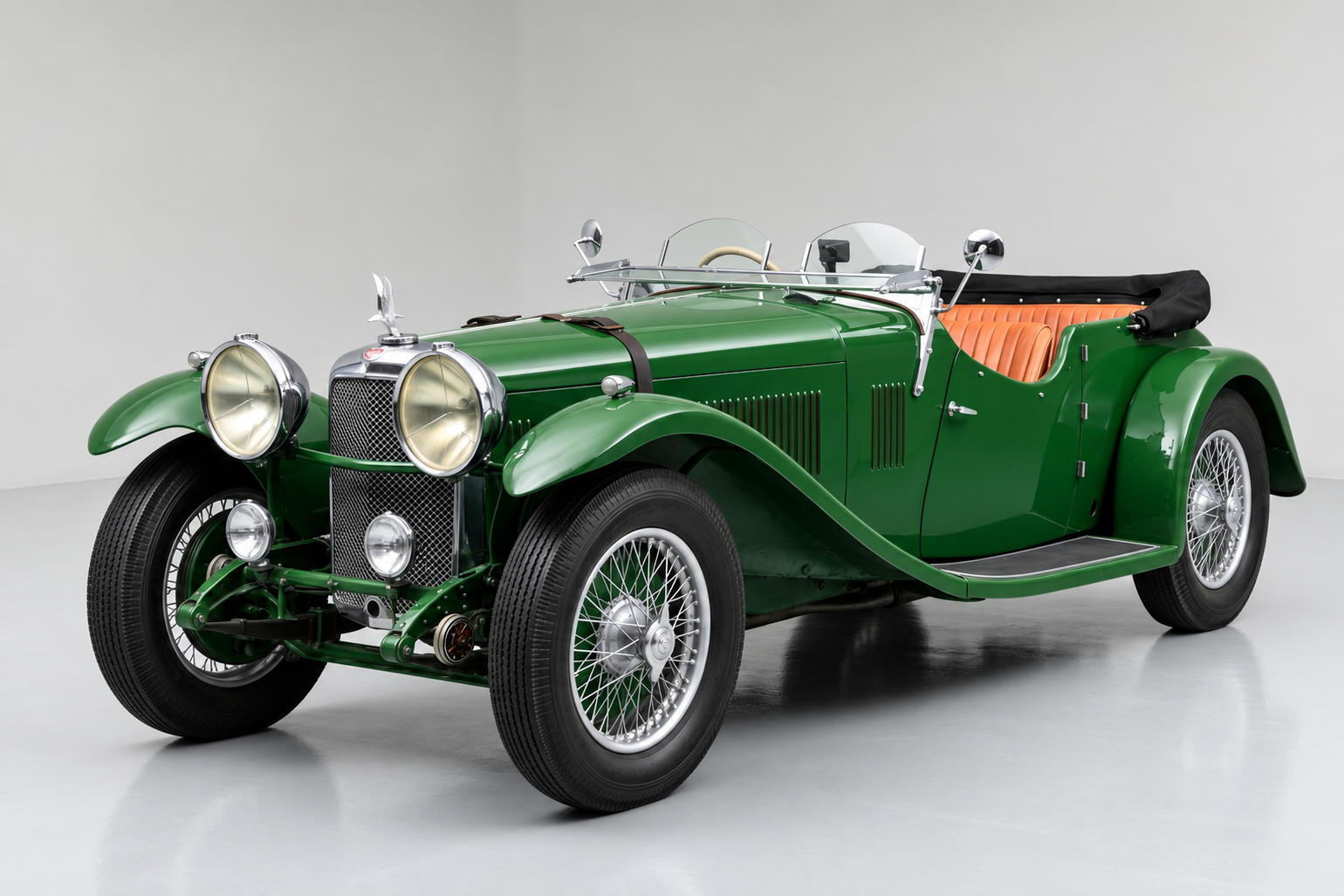 Green Alvis Speed 20 open tourer with the hood folded, front three-quarter view in a studio, showing the tall chrome radiator with eagle mascot, large chrome headlamps, cutaway doors, tan leather interior and centre-lock wire wheels.