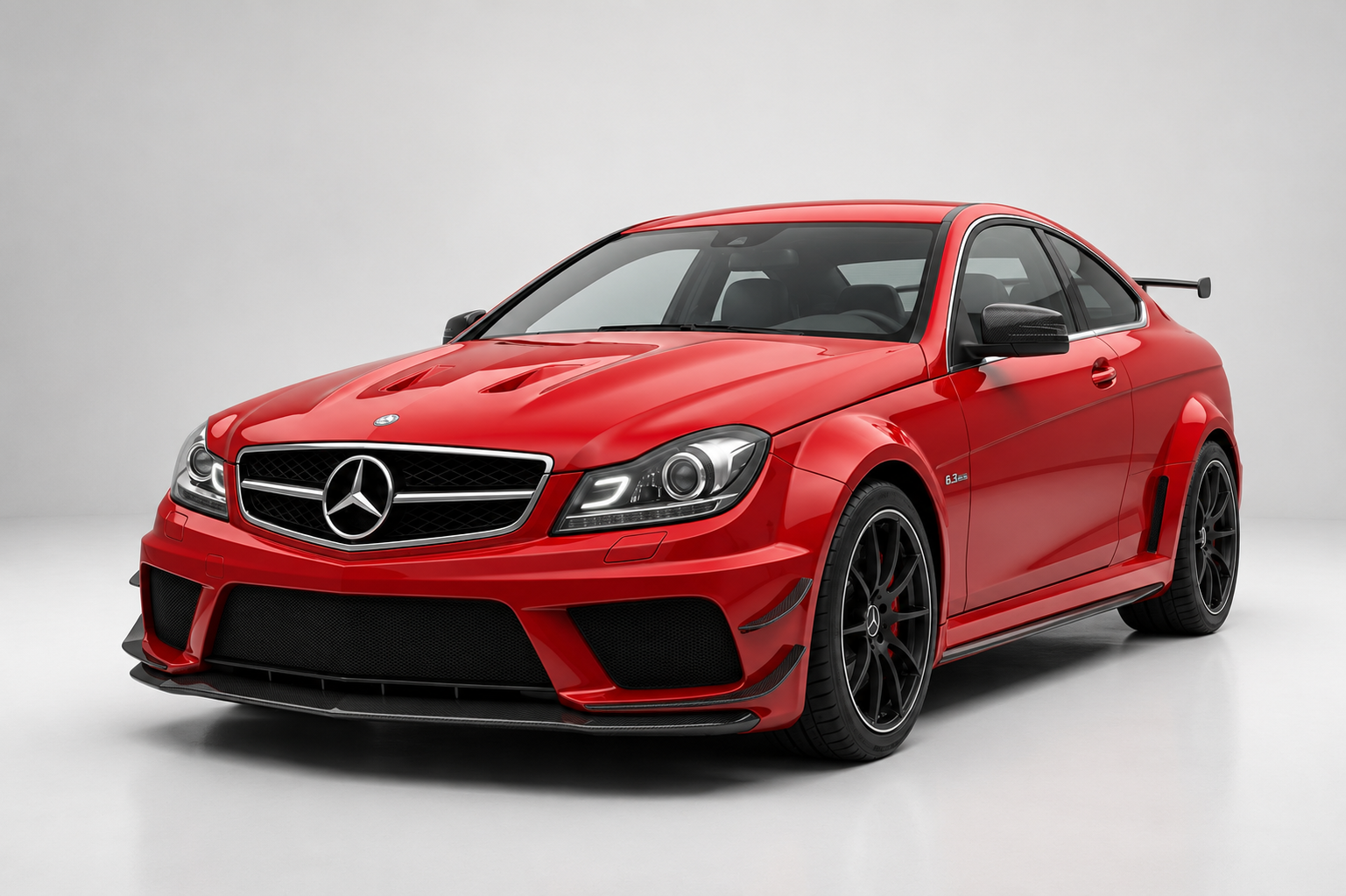 Red Mercedes-Benz C 63 AMG Coupé Black Series (W204) in a studio, front three-quarter view showing the widebody fenders, carbon front splitter, bonnet vents, rear wing and black forged AMG wheels.